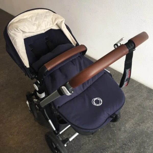 Customer photo: pram with a brown leather handlebar cover and carry bar cover by Re-Covers