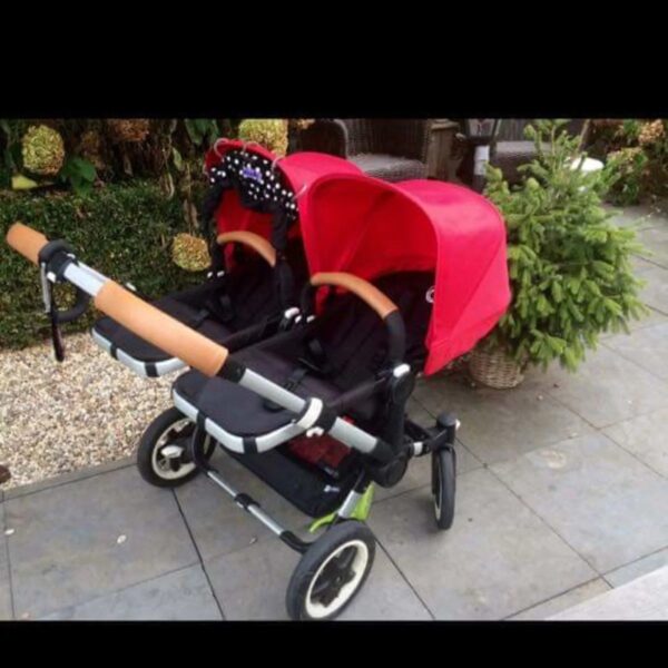 Customer photo: double pram with a cognac leather handlebar cover by Re-Covers